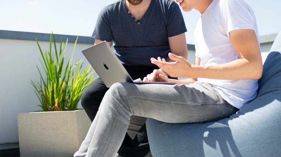 zwei Personen sitzen am Laptop an ihrer Bewerbung